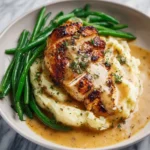Creamy garlic parmesan chicken breast served with fresh herbs.