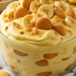 Delicious bowl of thick and creamy banana pudding topped with vanilla wafers