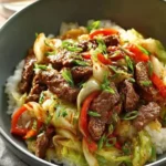 Delicious Beef and Cabbage Stir-Fry in a skillet with vibrant vegetables