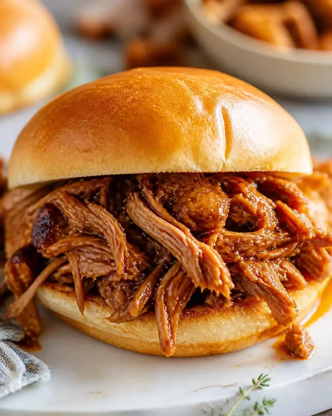 Delicious slow-cooker pulled pork served with barbecue sauce and buns