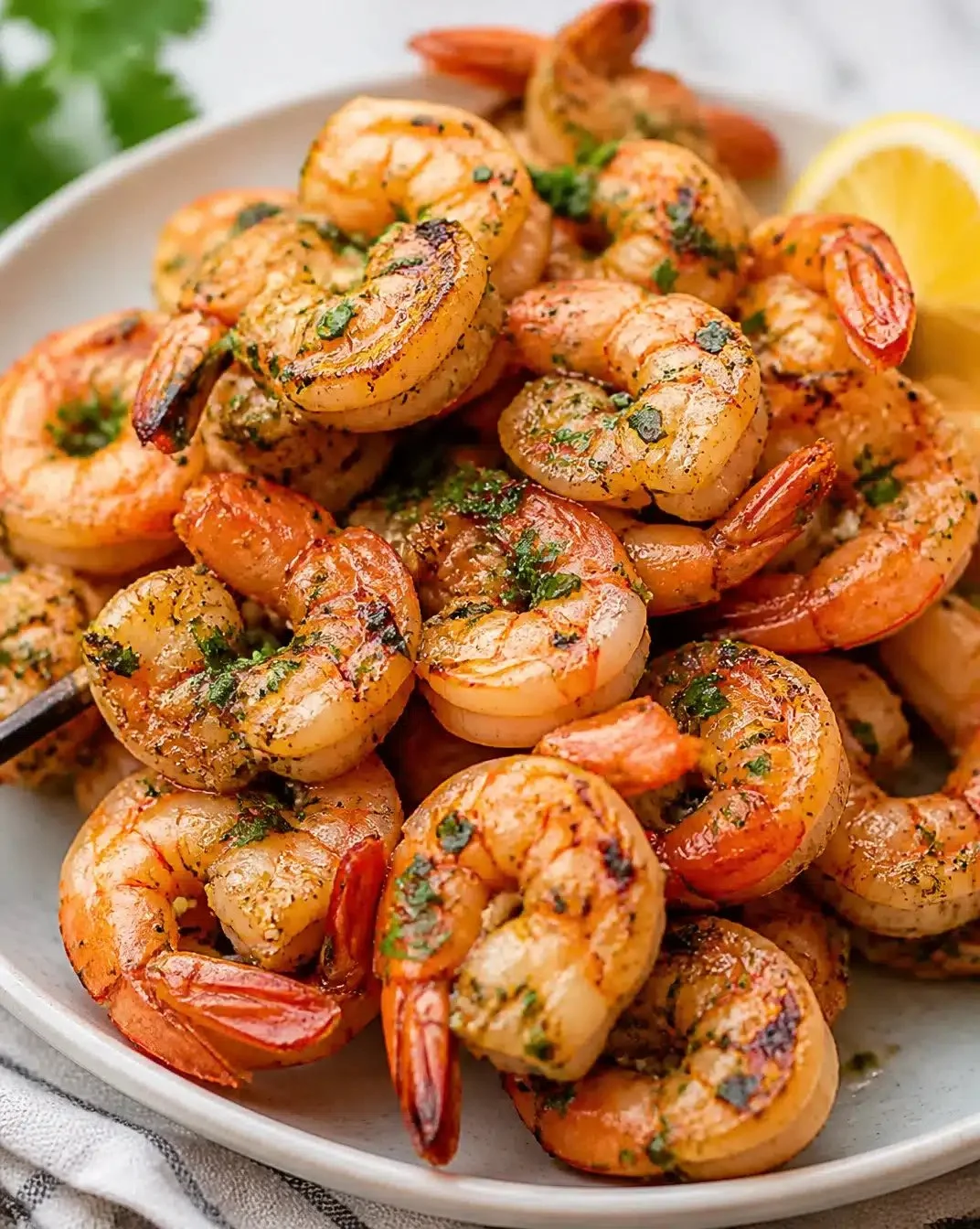 Delicious Garlic-Grilled Shrimp served with fresh herbs and lemon.