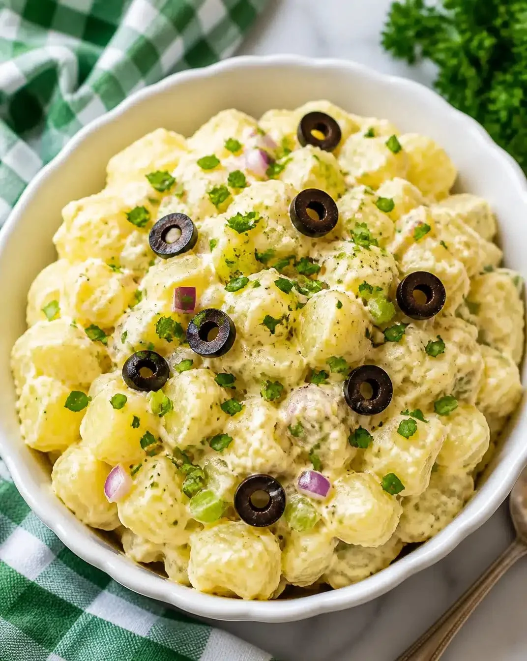 Ultimate Creamy Potato Salad 1 Delicious bowl of ultimate creamy potato salad garnished with herbs